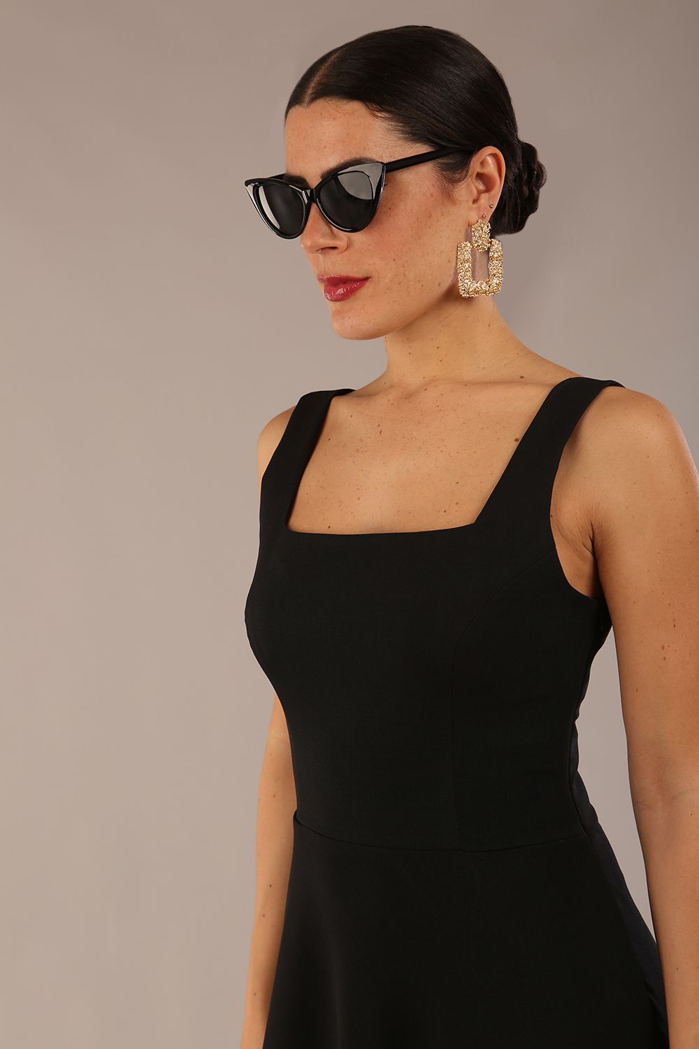 model wearing a diva catwalk Tamsin Square Neckline Swing Dress sleeveless style with a midaxi  length and side pockets in Black colour