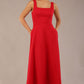 model wearing a diva catwalk Tamsin Square Neckline Swing Dress sleeveless style with a midaxi  length and side pockets in Scarlet Red colour