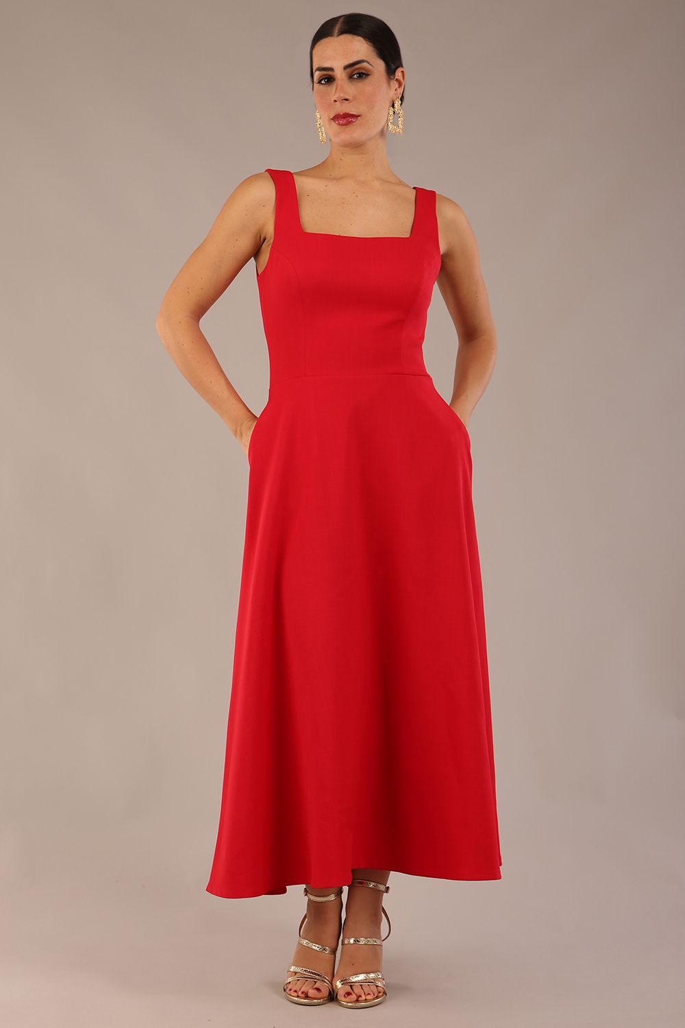 model wearing a diva catwalk Tamsin Square Neckline Swing Dress sleeveless style with a midaxi  length and side pockets in Scarlet Red colour