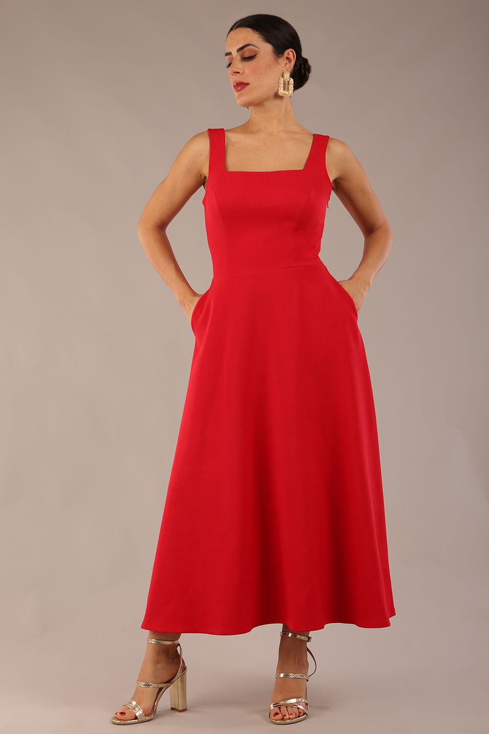 model wearing a diva catwalk Tamsin Square Neckline Swing Dress sleeveless style with a midaxi  length and side pockets in Scarlet Red colour