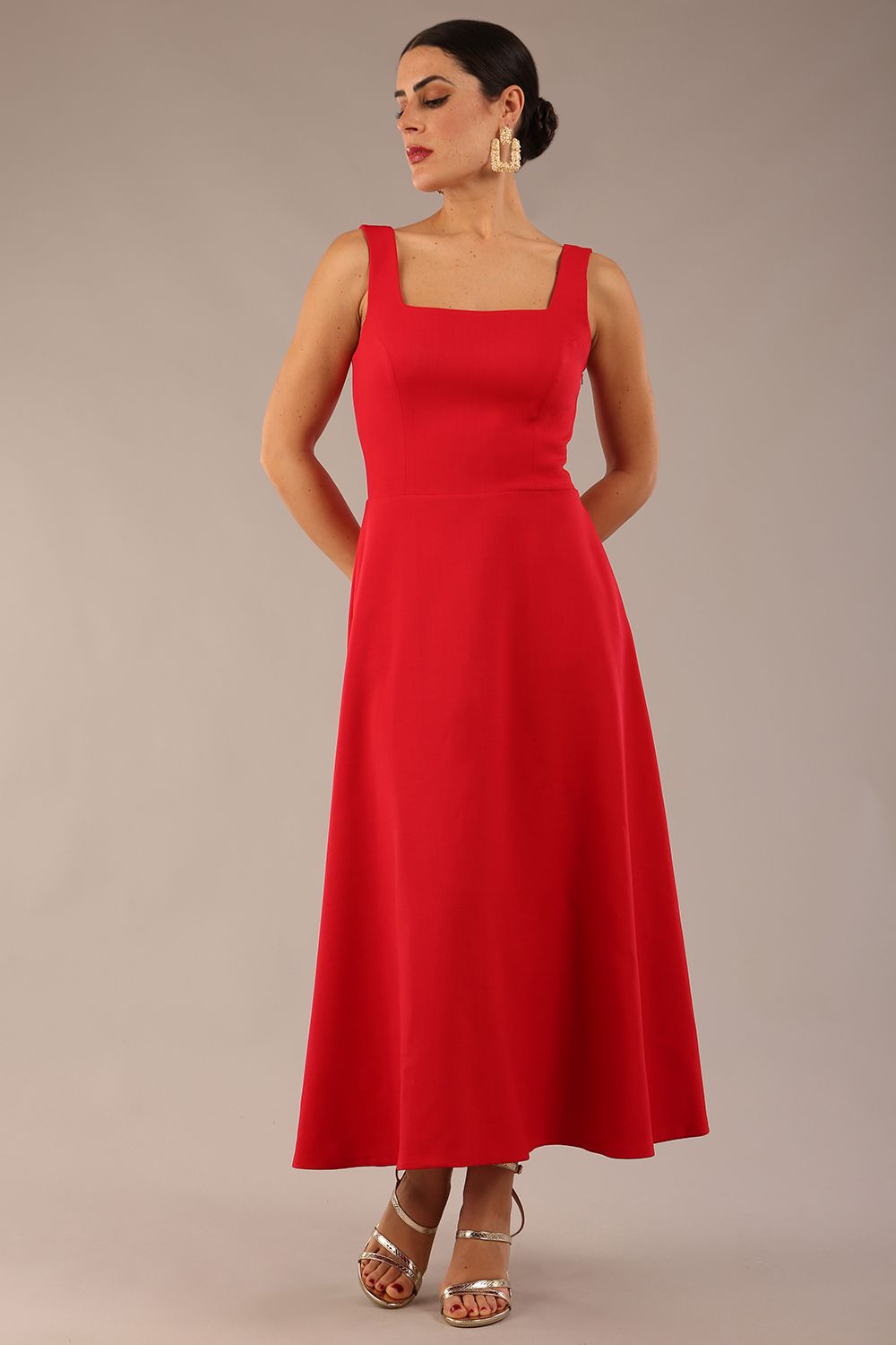 model wearing a diva catwalk Tamsin Square Neckline Swing Dress sleeveless style with a midaxi  length and side pockets in Scarlet Red colour