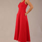 model wearing a diva catwalk Tamsin Square Neckline Swing Dress sleeveless style with a midaxi  length and side pockets in Scarlet Red colour