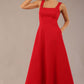 model wearing a diva catwalk Tamsin Square Neckline Swing Dress sleeveless style with a midaxi  length and side pockets in Scarlet Red colour