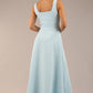brunette model is wearing a diva catwalk Tamsin Square Neckline Swing Dress sleeveless style with a midaxi  length and side pockets in Sky blue colour back