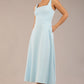 brunette model is wearing a diva catwalk Tamsin Square Neckline Swing Dress sleeveless style with a midaxi  length and side pockets in Sky blue colour front