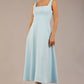 brunette model is wearing a diva catwalk Tamsin Square Neckline Swing Dress sleeveless style with a midaxi  length and side pockets in Sky blue colour front