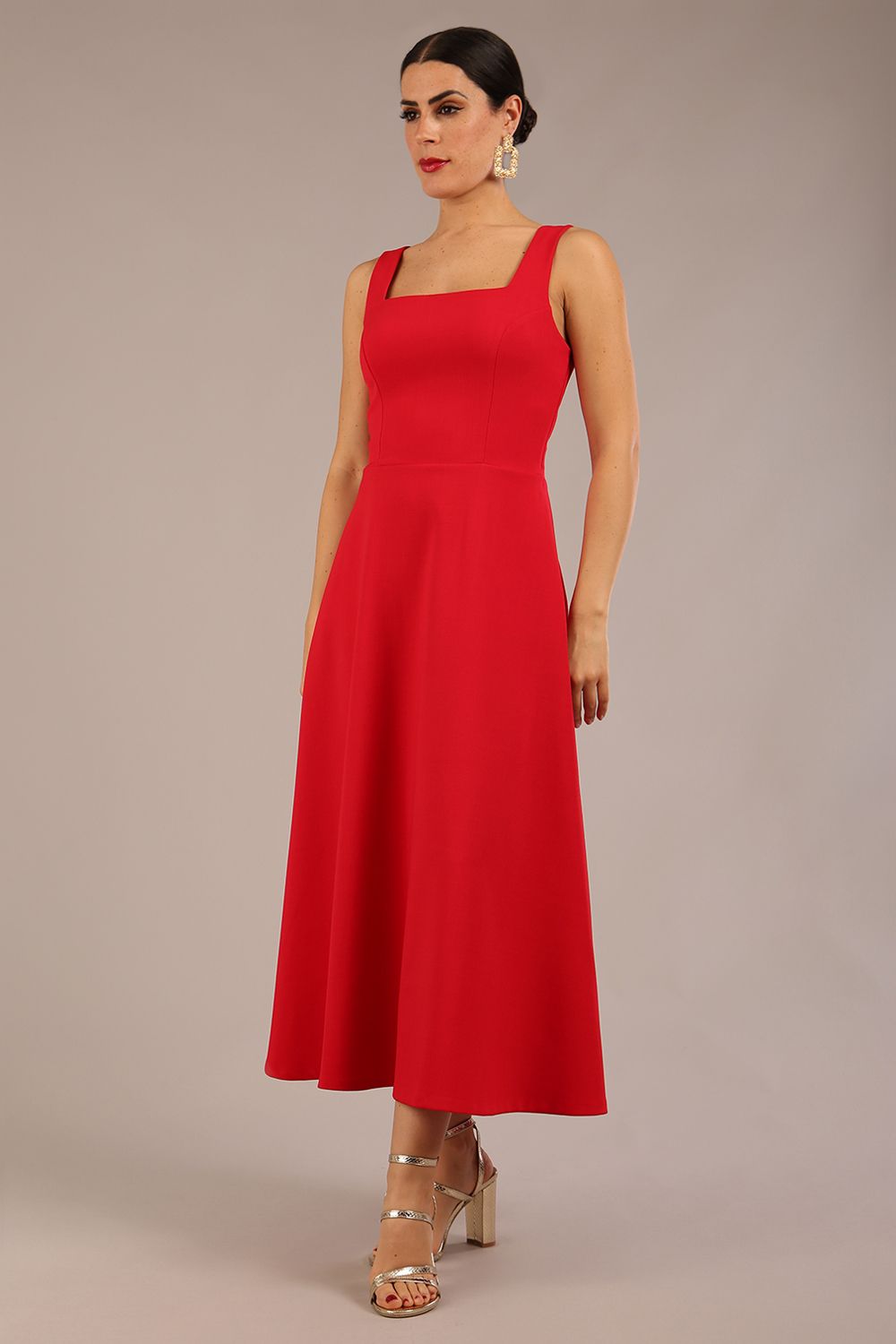 brunette model is wearing a diva catwalk Tamsin Square Neckline Swing Dress sleeveless style with a midaxi  length and side pockets in scarlet red colour front