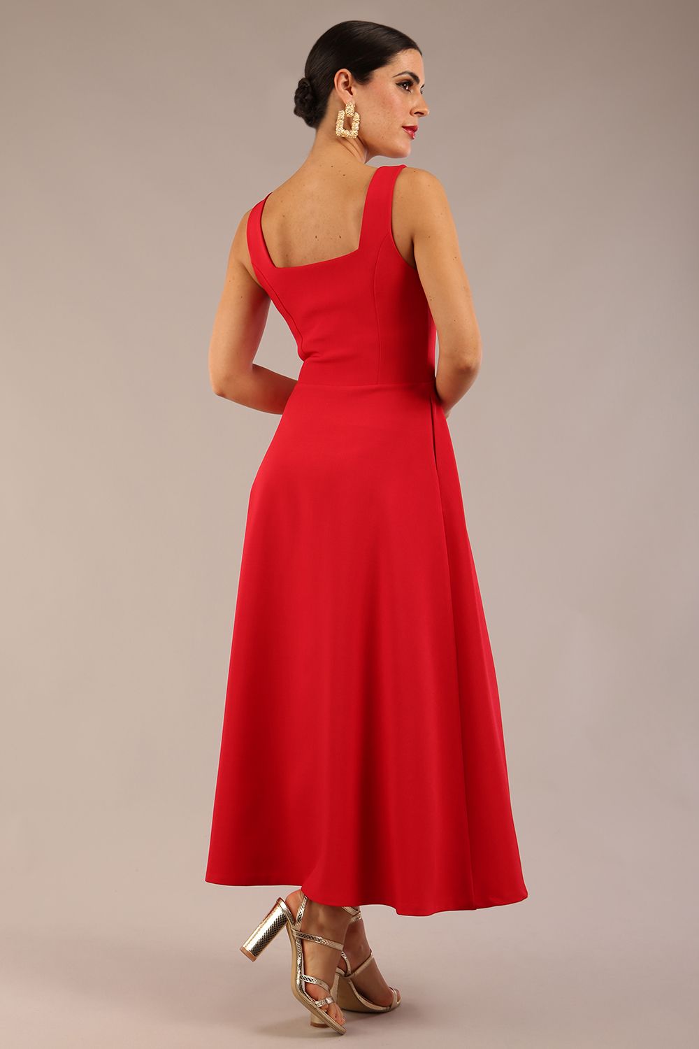 brunette model is wearing a diva catwalk Tamsin Square Neckline Swing Dress sleeveless style with a midaxi  length and side pockets in scarlet red colour back