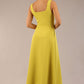 brunette model is wearing a diva catwalk Tamsin Square Neckline Swing Dress sleeveless style with a midaxi  length and side pockets in Citrus green colour back
