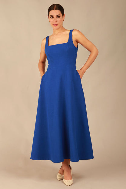 model wearing a diva catwalk Tamsin Square Neckline Swing Dress sleeveless style with a midaxi  length and side pockets in cobalt blue colour