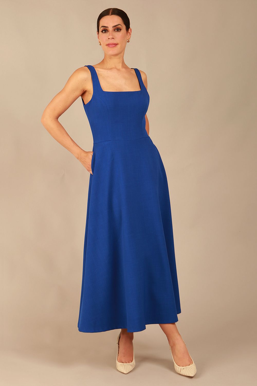 model wearing a diva catwalk Tamsin Square Neckline Swing Dress sleeveless style with a midaxi  length and side pockets in cobalt blue colour