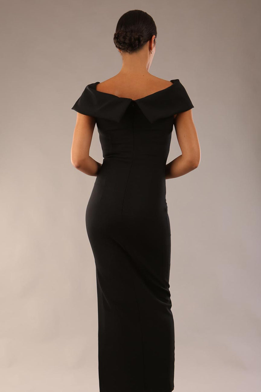 model is wearing a diva catwalk Mariposa Longer Length Dress off the shoulder bardot neckline and midaxi length in Black colour