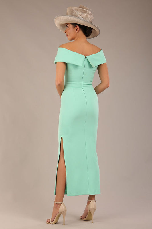 brunette model is wearing a diva catwalk Mariposa Longer Length Dress off the shoulder bardot neckline and midaxi length in mint green colour back image