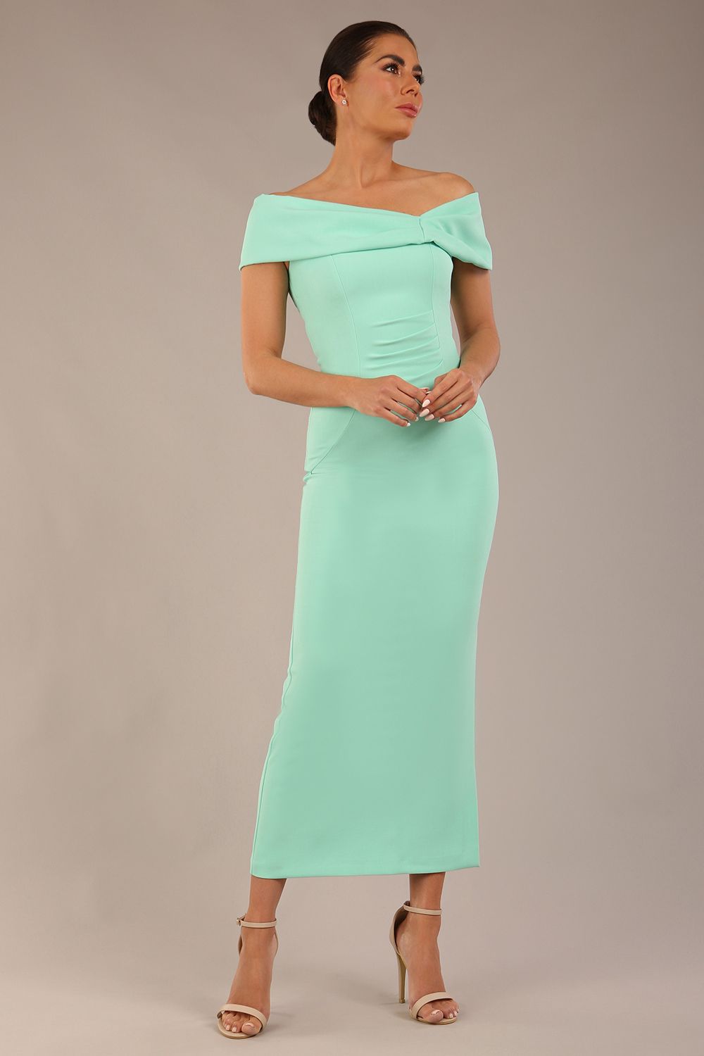 brunette model is wearing a diva catwalk Mariposa Longer Length Dress off the shoulder bardot neckline and midaxi length in mint green colour front image