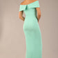brunette model is wearing a diva catwalk Mariposa Longer Length Dress off the shoulder bardot neckline and midaxi length in mint green colour back image