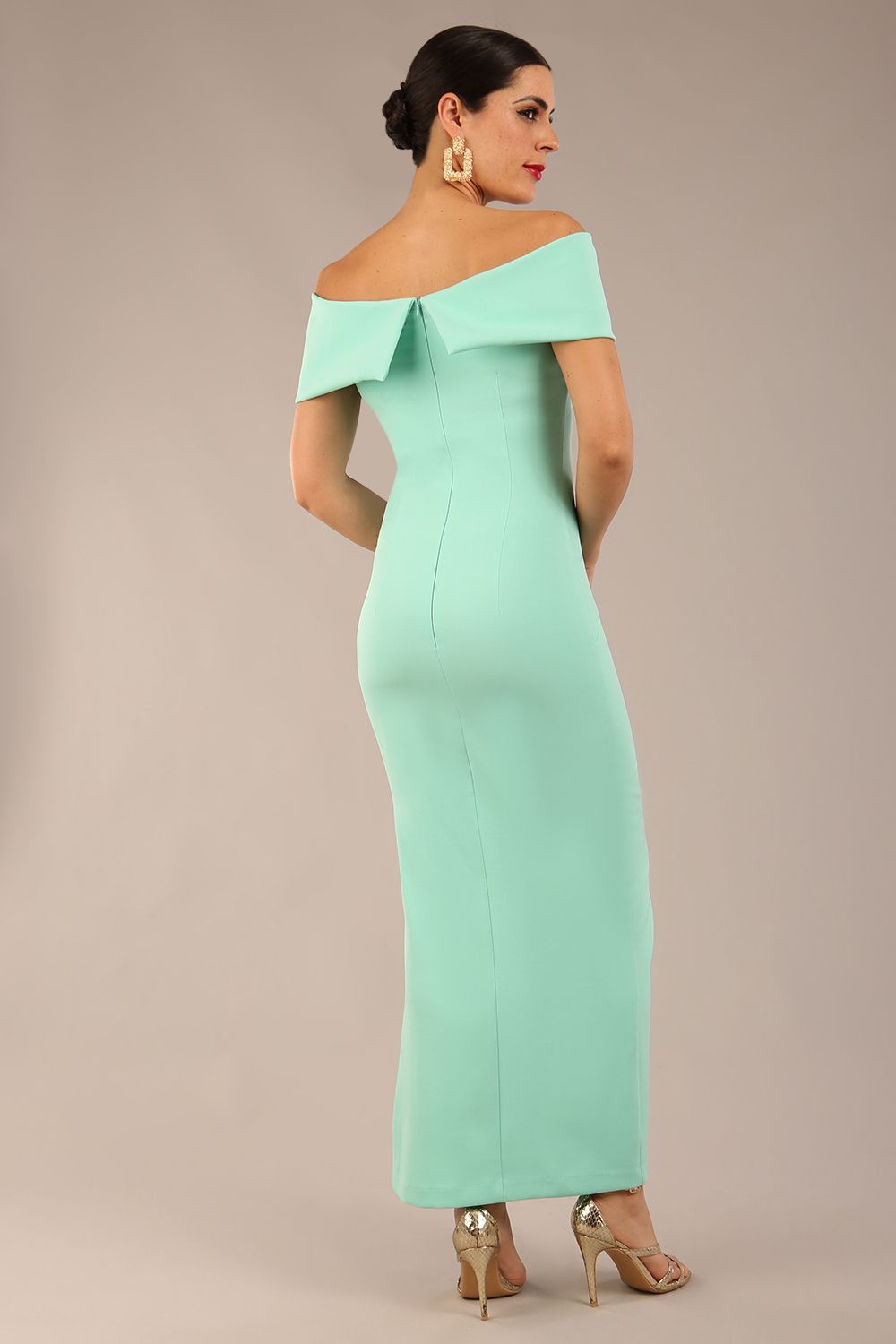 brunette model is wearing a diva catwalk Mariposa Longer Length Dress off the shoulder bardot neckline and midaxi length in mint green colour back image