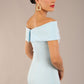 brunette model is wearing a diva catwalk Mariposa Longer Length Dress off the shoulder bardot neckline and midaxi length in sky blue colour back image close up