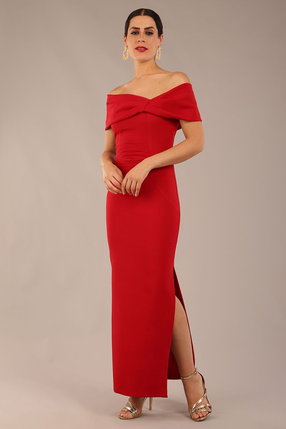 brunette model is wearing a diva catwalk Mariposa Longer Length Dress off the shoulder bardot neckline and midaxi length in dark red colour front image