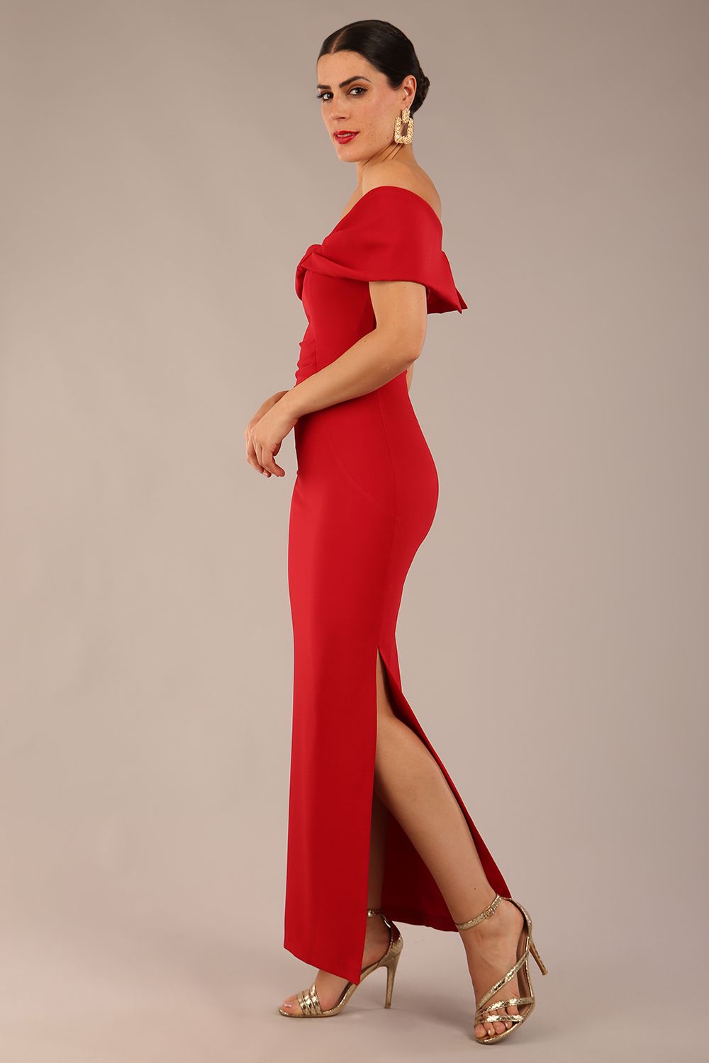 brunette model is wearing a diva catwalk Mariposa Longer Length Dress off the shoulder bardot neckline and midaxi length in dark red colour front image