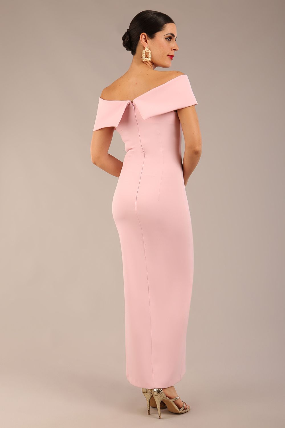 brunette model is wearing a diva catwalk Mariposa Longer Length Dress off the shoulder bardot neckline and midaxi length in crystal pink colour back image