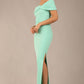 brunette model is wearing a diva catwalk Mariposa Longer Length Dress off the shoulder bardot neckline and midaxi length in mint green colour front image