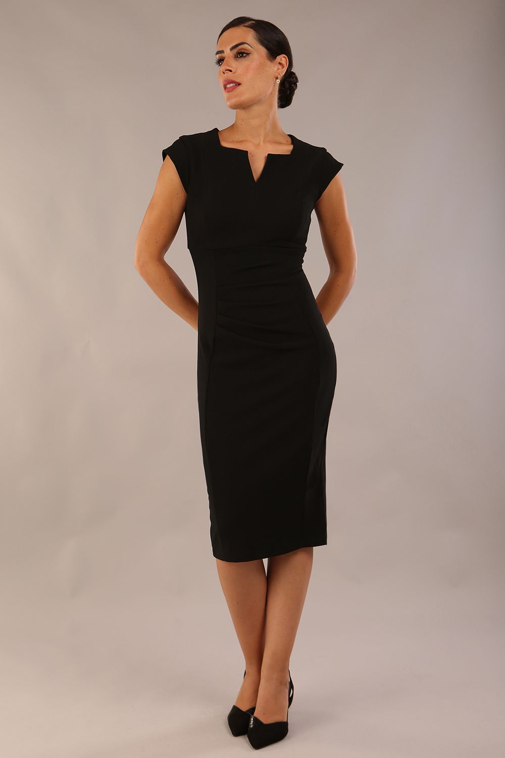 model wearing a diva catwalk Thea Cap Sleeved Pencil Dress with square neckline with a v-slit and knee length in ribbed super stretch fabric in black front