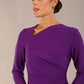 model wearing a diva catwalk Asymetric 3/4 Sleeves Pencil Dress with 3/4 sleeves knee length and asymmetric neckline in passion purple colour front image