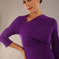 model wearing a diva catwalk Asymetric 3/4 Sleeves Pencil Dress with 3/4 sleeves knee length and asymmetric neckline in passion purple colour front image close up