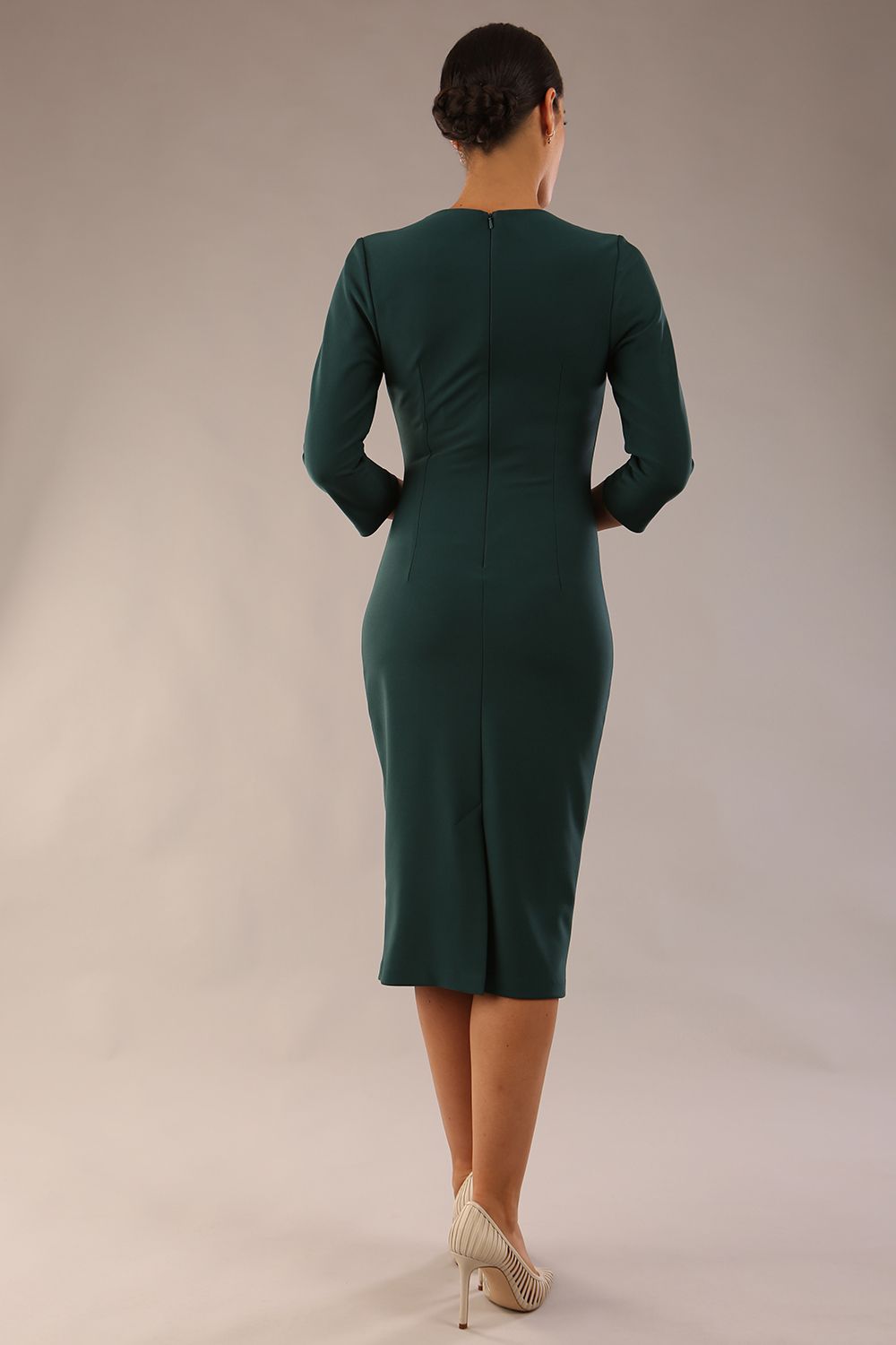 model wearing a diva catwalk Asymetric 3/4 Sleeves Pencil Dress with 3/4 sleeves knee length and asymmetric neckline in forest green colour back image