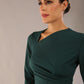 model wearing a diva catwalk Asymetric 3/4 Sleeves Pencil Dress with 3/4 sleeves knee length and asymmetric neckline in forest green colour front image