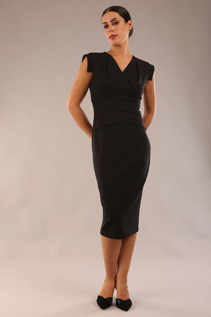 model wearing a diva catwalk Caprice Cap Sleeved Pencil Dress cap sleeve v neckline knee length with pleating details in black colour