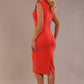 model wearing a diva catwalk Caprice Cap Sleeved Pencil Dress cap sleeve v neckline knee length with pleating details in grenadine orange colour back