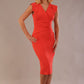 model wearing a diva catwalk Caprice Cap Sleeved Pencil Dress cap sleeve v neckline knee length with pleating details in grenadine orange colour front