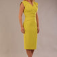 model wearing a diva catwalk Caprice Cap Sleeved Pencil Dress cap sleeve v neckline knee length with pleating details in citrus green colour front side