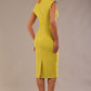 model wearing a diva catwalk Caprice Cap Sleeved Pencil Dress cap sleeve v neckline knee length with pleating details in citrus green colour back