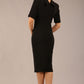 brunette model is wearing a diva catwalk Highmoor Short Sleeved Pencil Dress high neckline and shoulders pad in black colour back image
