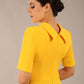 brunette model is wearing a diva catwalk Highmoor Short Sleeved Pencil Dress high neckline and shoulders pad in sunshine yellow colour back image close up