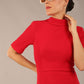 brunette model is wearing a diva catwalk Highmoor Short Sleeved Pencil Dress high neckline and shoulders pad in true red colour front image
