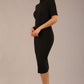 brunette model is wearing a diva catwalk Highmoor Short Sleeved Pencil Dress high neckline and shoulders pad in black colour front image