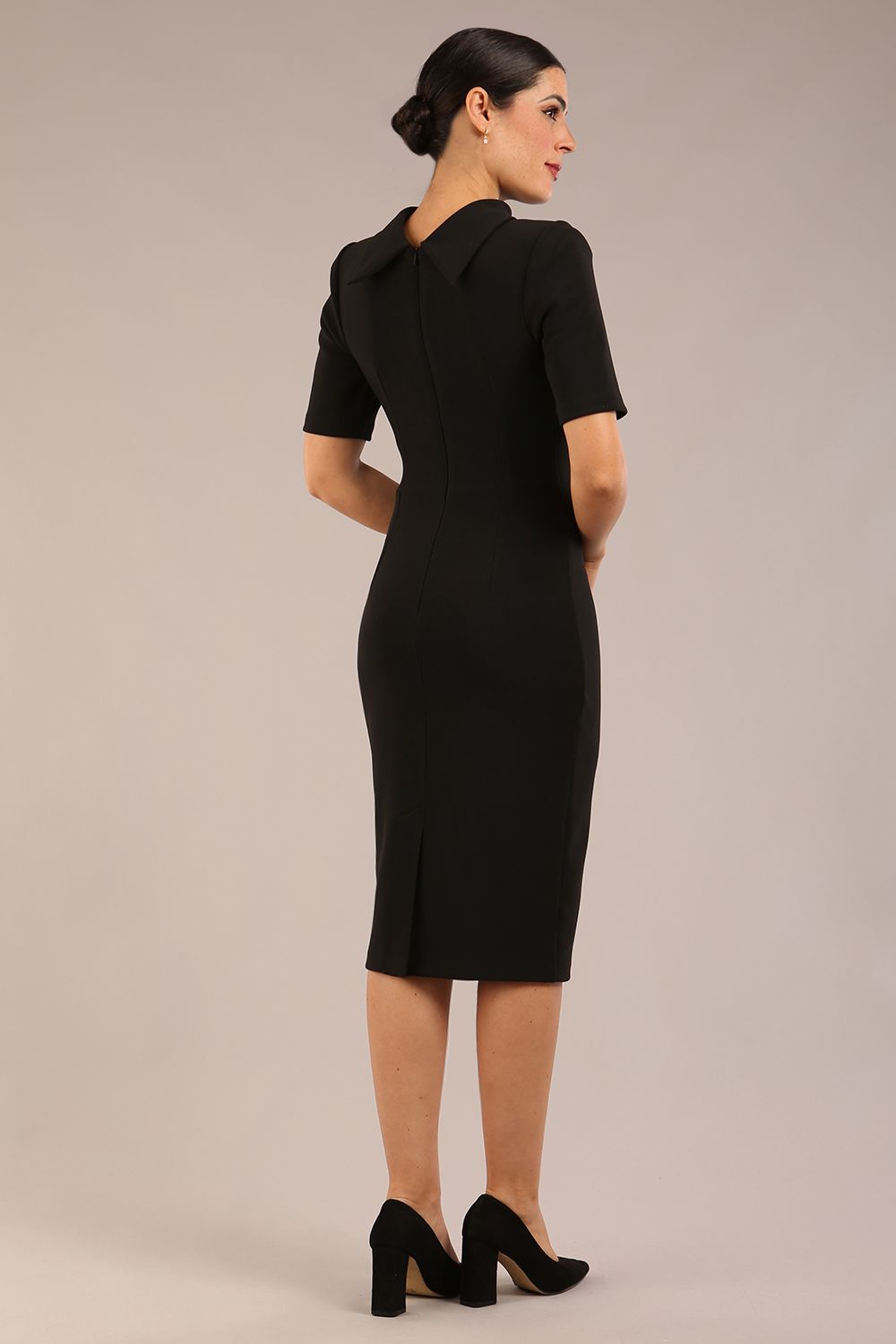 model is wearing a diva catwalk Highmoor Short Sleeved Pencil Dress high neckline and shoulders pads in black colour back