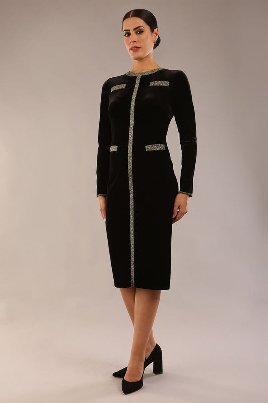 model wearing a diva catwalk Caspian Glitter Contrast Pencil Dress in velvet fabric with glitter contrast on neckline, bodice and cuff and long sleeves knee length pencil dress with faux pockets in black and gold glitter