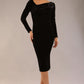 model is wearing a diva catwalk Renoir Long Sleeve Velvet Dress long sleeves midi length with side vent and asymmetric neckline and pleating details in black velvet