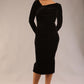 model is wearing a diva catwalk Renoir Long Sleeve Velvet Dress long sleeves midi length with side vent and asymmetric neckline and pleating details in black velvet