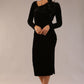 model is wearing a diva catwalk Renoir Long Sleeve Velvet Dress long sleeves midi length with side vent and asymmetric neckline and pleating details in black velvet