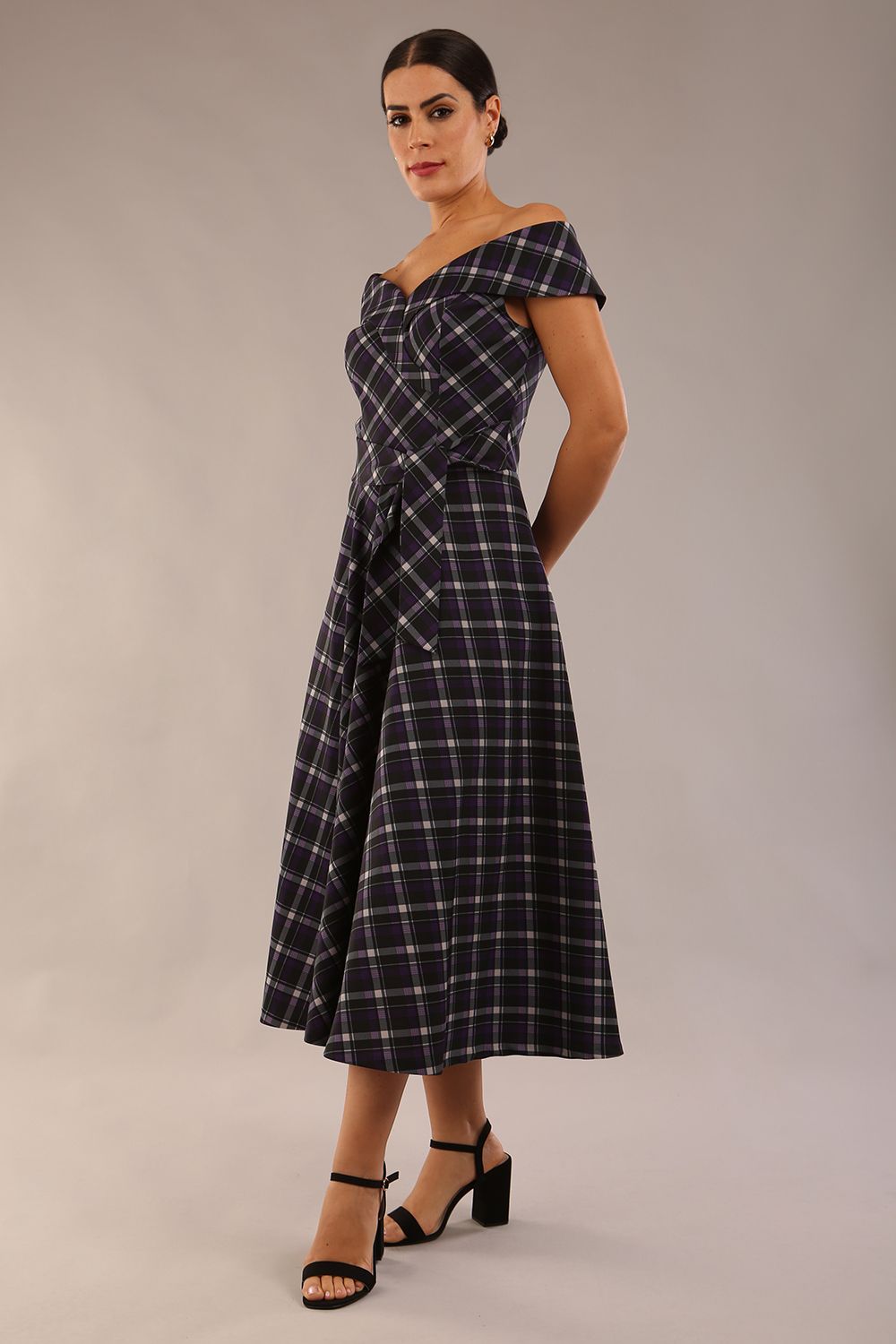 model is wearing a diva catwalk Montclair Tartan Off-Shoulder Midi Dress bardot neckline with tie detail at the waist area a-line style in royal purple tartan colour