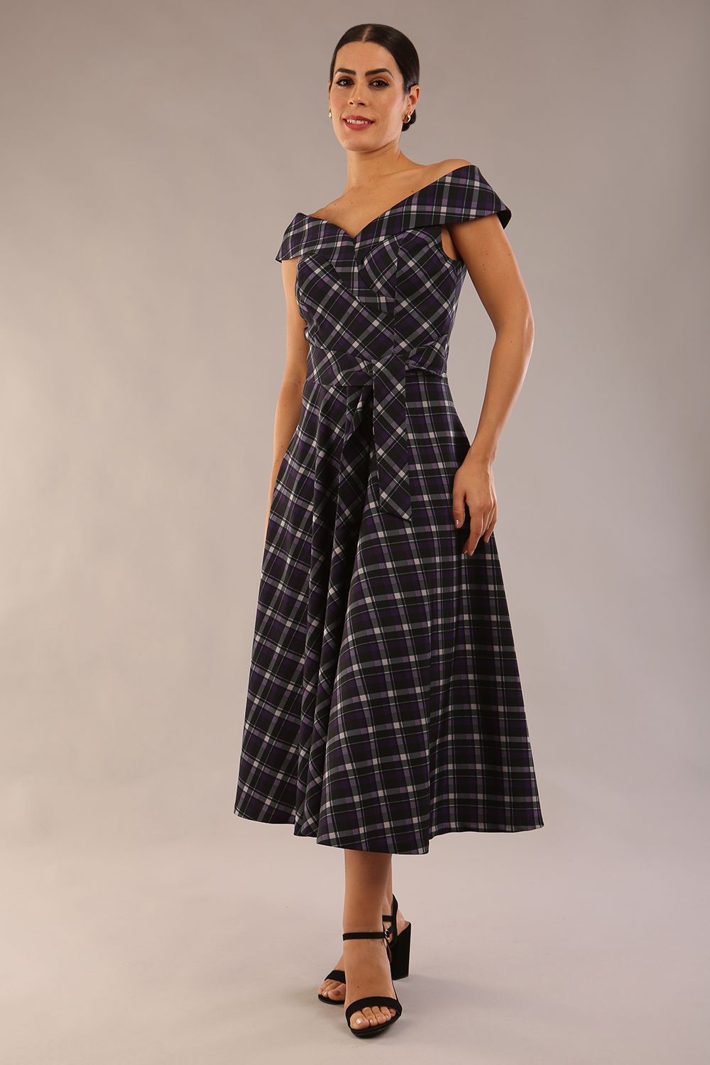 model is wearing a diva catwalk Montclair Tartan Off-Shoulder Midi Dress bardot neckline with tie detail at the waist area a-line style in royal purple tartan colour