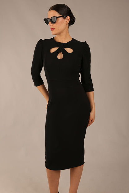 model is wearing a diva catwalk Quintessa Three Petal Keyhole Pencil Dress with 3/4 sleeves round neckline a below the knee length in black colour