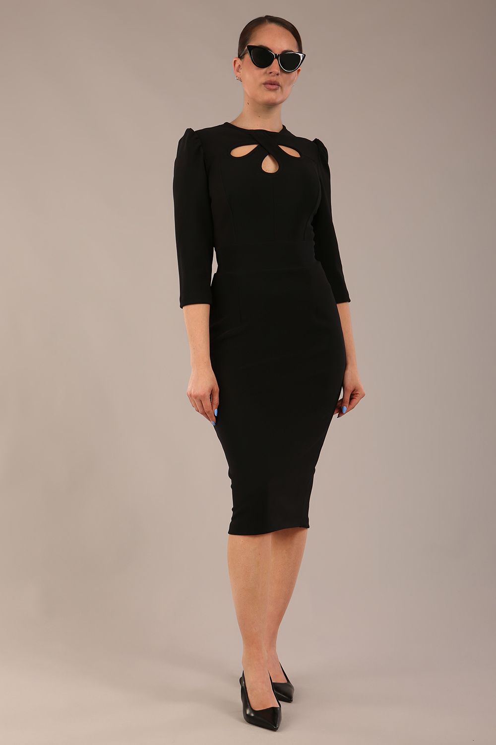 model is wearing a diva catwalk Quintessa Three Petal Keyhole Pencil Dress with 3/4 sleeves round neckline a below the knee length in black colour