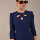 model is wearing a diva catwalk Quintessa Three Petal Keyhole Pencil Dress with 3/4 sleeves round neckline a below the knee length in navy blue colour