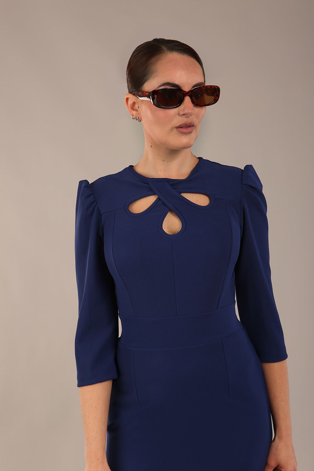 model is wearing a diva catwalk Quintessa Three Petal Keyhole Pencil Dress with 3/4 sleeves round neckline a below the knee length in navy blue colour
